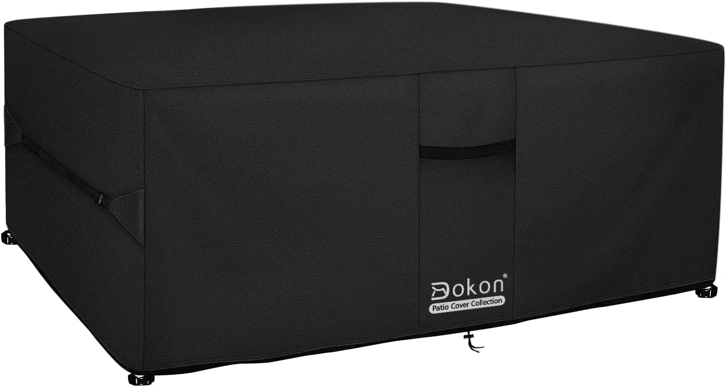 Black Dokon square garden furniture cover fitted over a patio set, showing side straps and carry handle