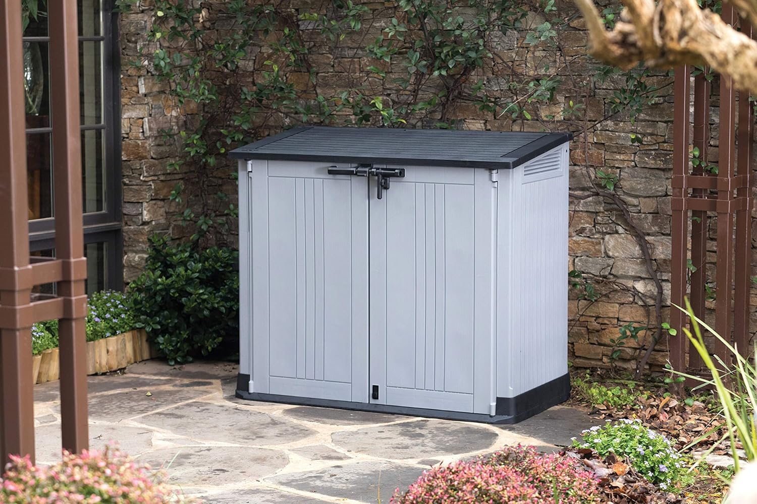 Close detail of the Keter Store It Out Nova storage shed showing the wood-effect plastic panel texture