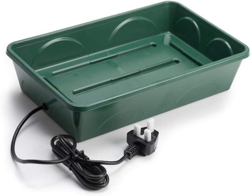 Empty green injection-moulded propagator base showing the ribbed bottom and UK three-pin plug lead