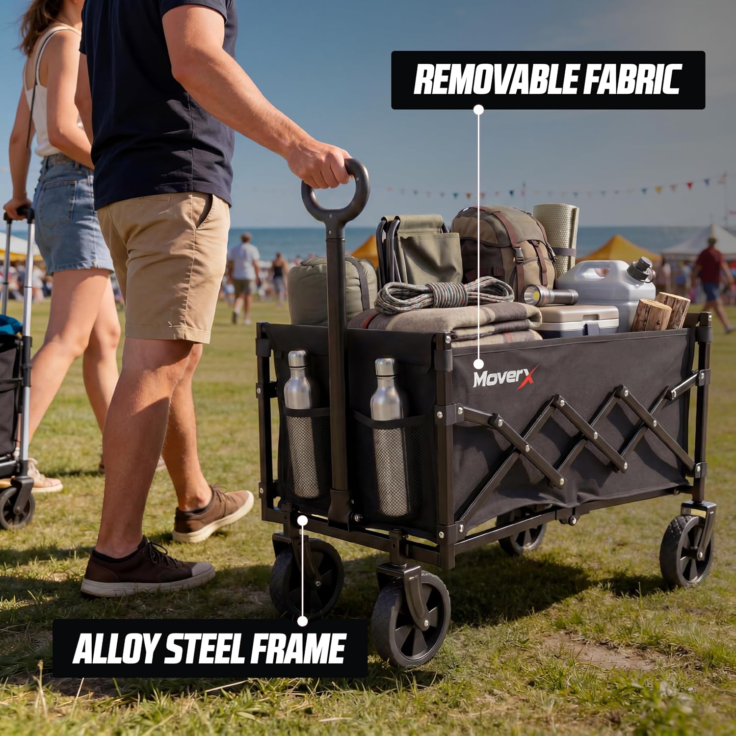 A man pulling the loaded MoverX trolley by its extended handle across festival grass