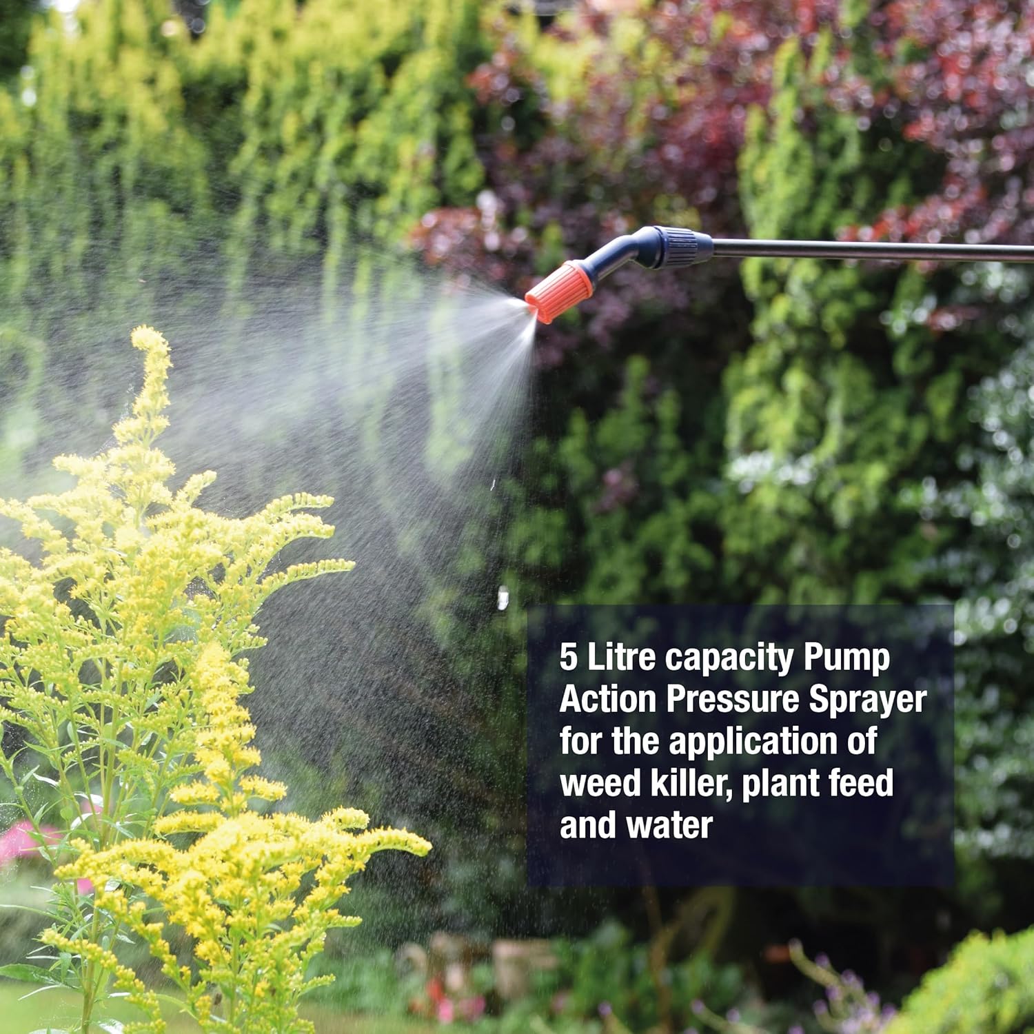 Spear & Jackson 5LPAPS adjustable nozzle producing a fine mist spray over flowering garden plants