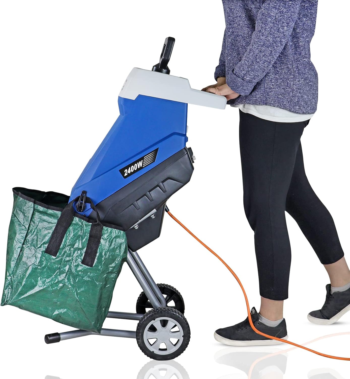 A user wheeling the Hyundai shredder tilted back on its two wheels with the collection bag attached and the power cable trailing behind