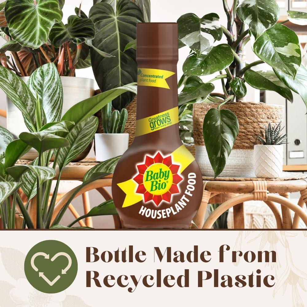 Baby Bio bottle photographed against tropical green foliage with recycled plastic badge visible