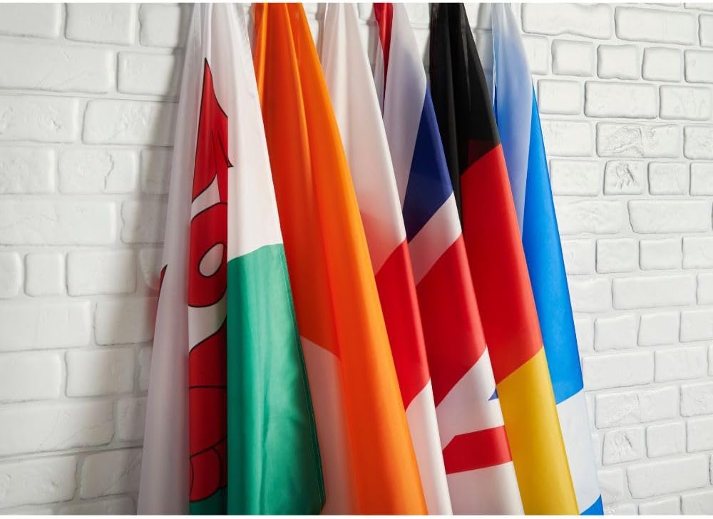 Several flags from the Runesol range hanging side by side on a white wall