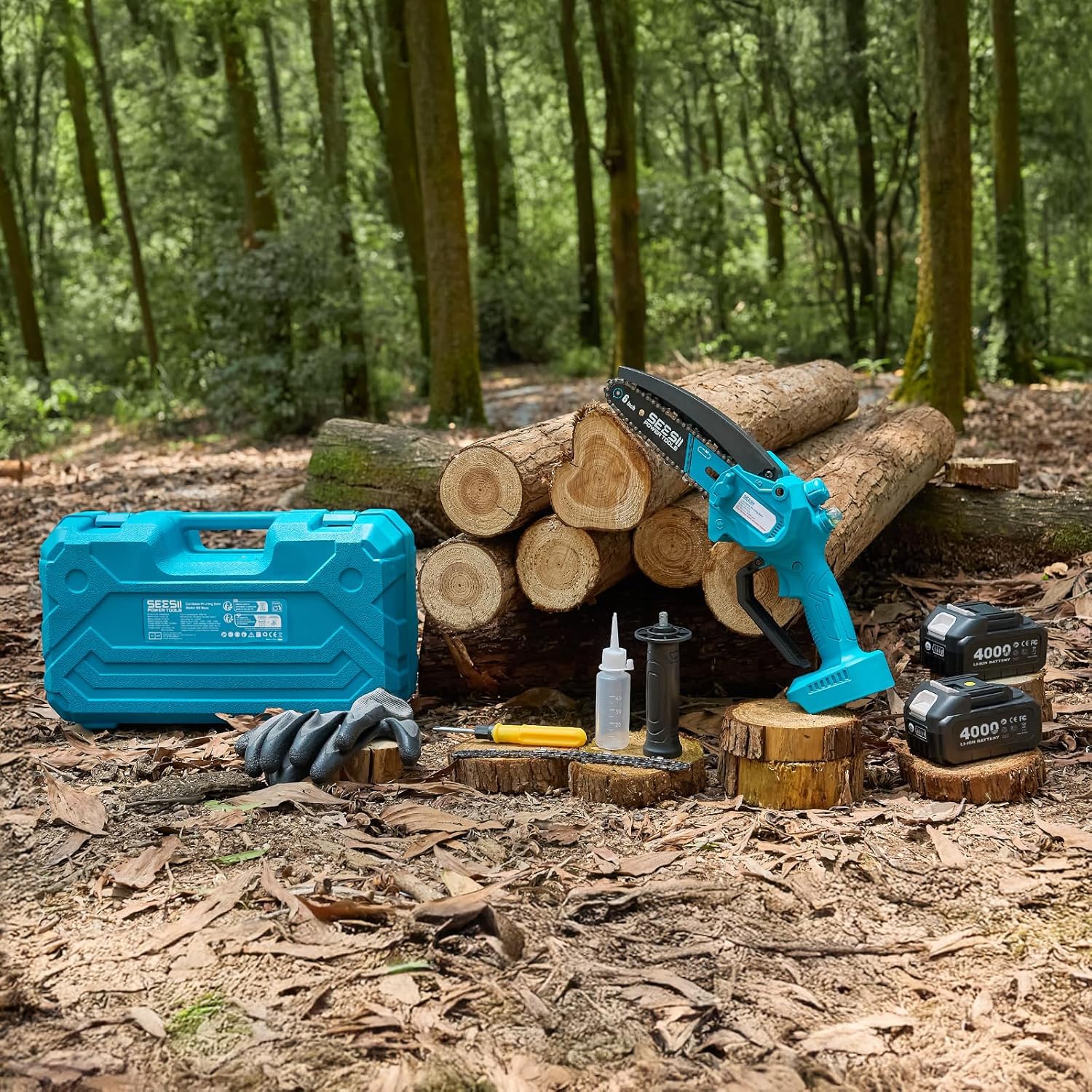 The full Seesii kit laid out on woodland ground: blue hard case, gloves, chain oil bottle, spare chain, screwdriver, auxiliary handle and two batteries