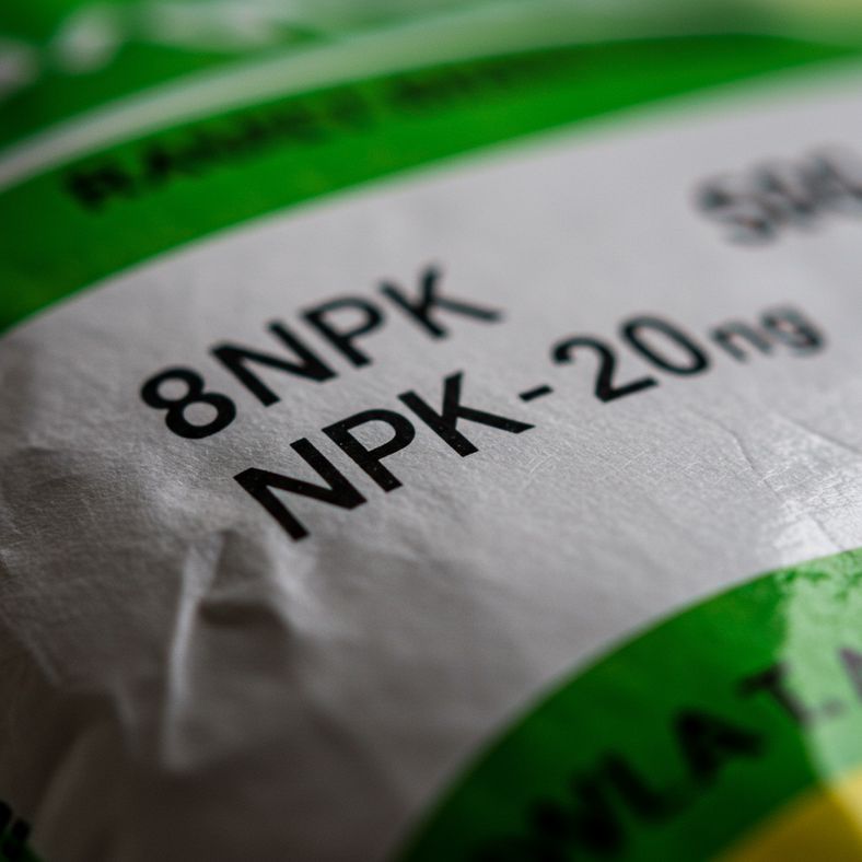 Close-up of NPK fertilizer ratio label showing 10-5-10 numbers on organic tomato fertilizer package