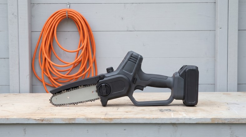 Cordless pruning saw with battery removed ready for indoor winter storage in the UK