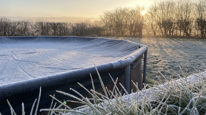 Frost on the winter cover of an above ground pool during a monthly winter check in the UK
